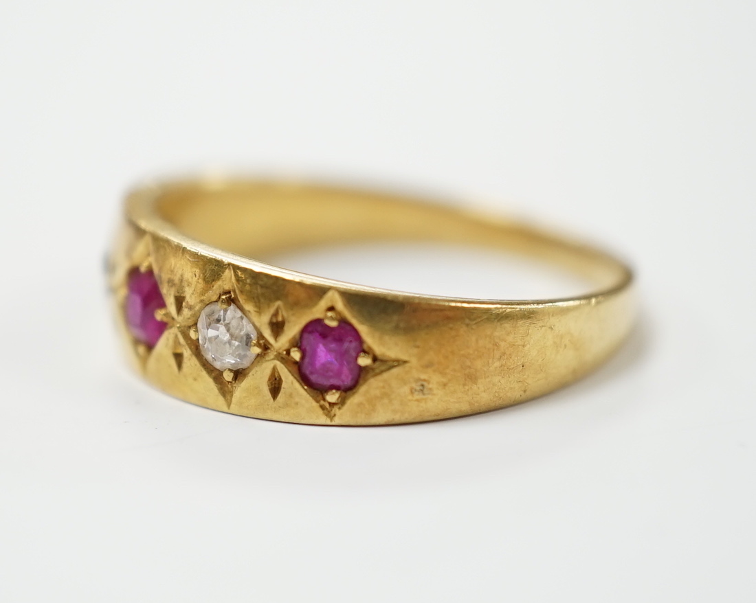 An early 20th century yellow metal ruby and diamond set five stone dress ring, size P